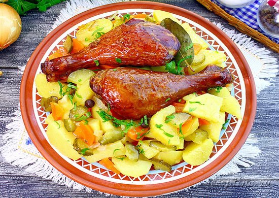Копченые куриные голени, тушеные с картофелем и солеными огурцами раскладывают по тарелкам и посыпают измельченной петрушкой. ш-11